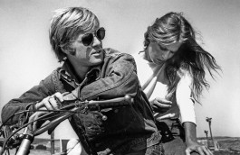 Camera Work exhibition, black and white photo of Robert Redford and Lauren Hutton sitting on a bicycle