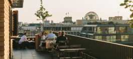 Château Royal rooftop terrace, people sitting at tables, drinking and chatting
