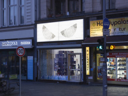 Chert Lüdde exhibition, photo Light box on top of a shop on the street with art by Ruth Wolf-Rehfeldt