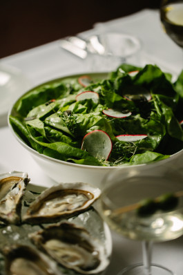Le Petit Royal photo of the table, salad on the plate, next to it a plate with oysters